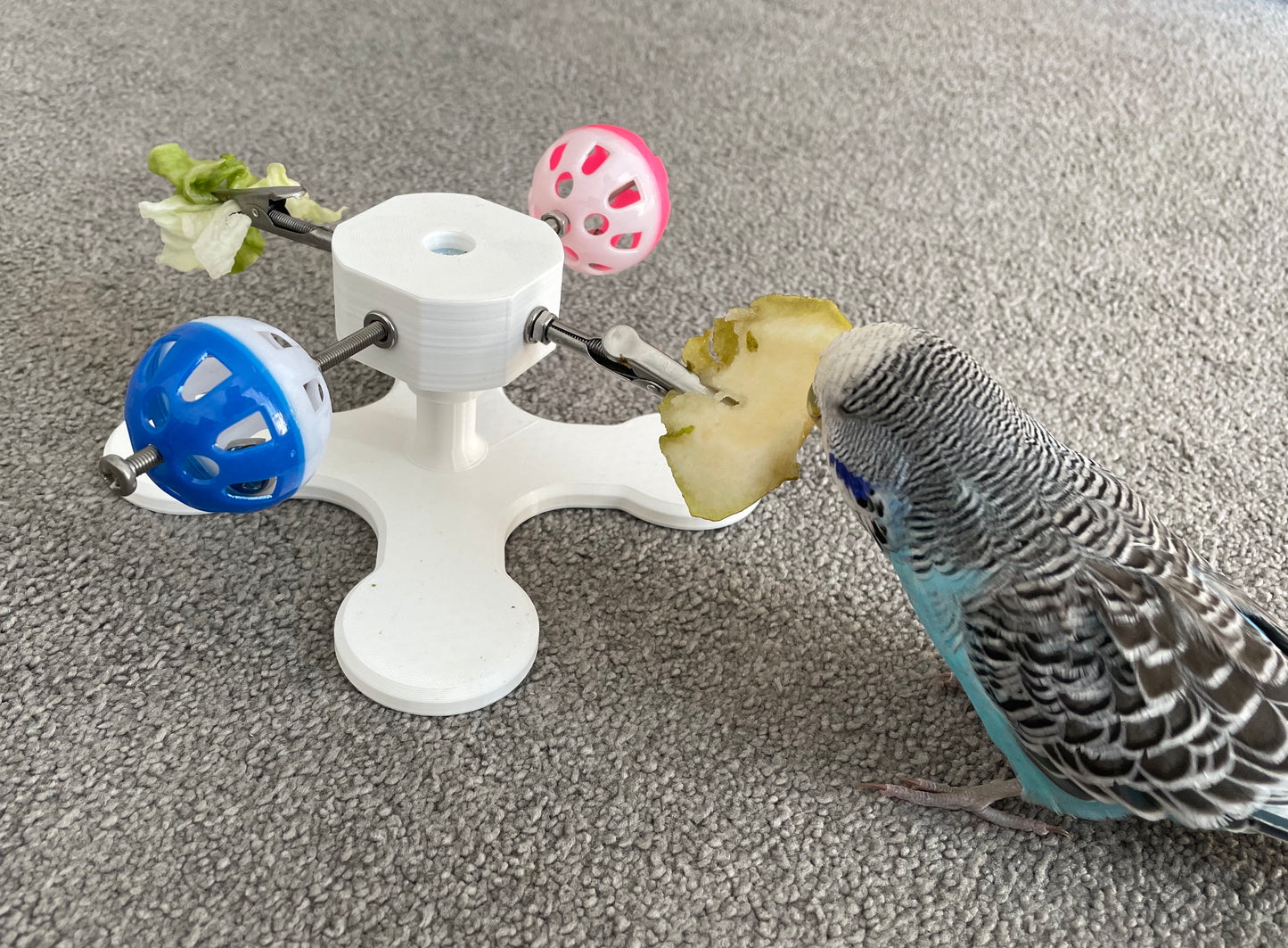 Rotating Bird Toy With Food Clips To Hold Treats.