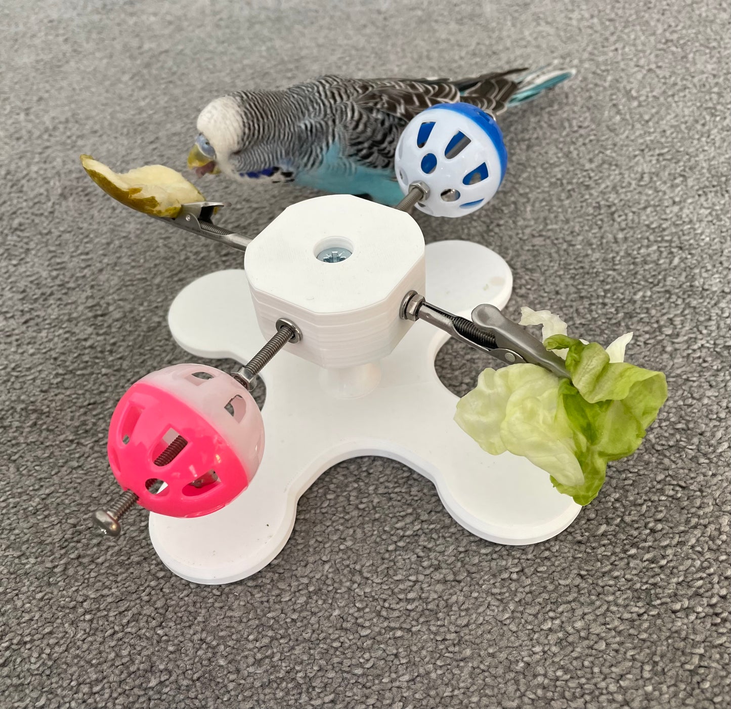 Rotating Bird Toy With Food Clips To Hold Treats.