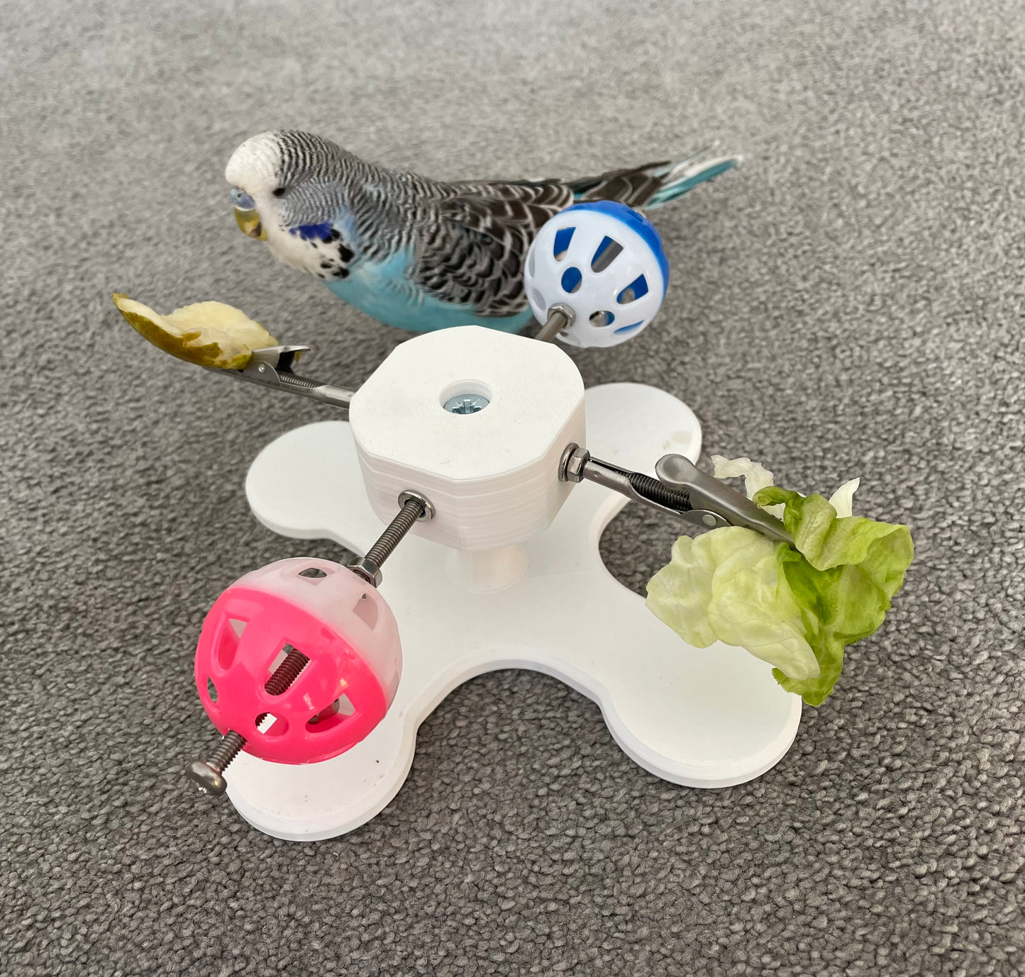 Rotating Bird Toy With Food Clips To Hold Treats.