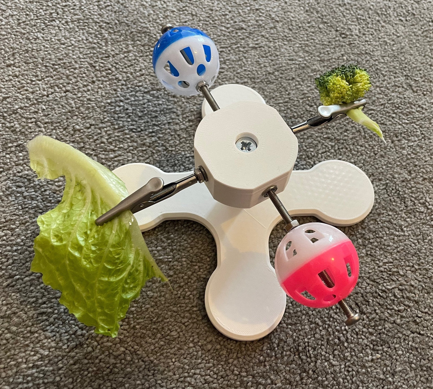 Rotating Bird Toy With Food Clips To Hold Treats.