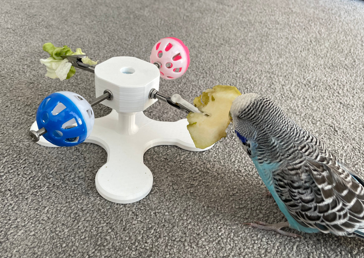 Rotating Bird Toy With Food Clips To Hold Treats.