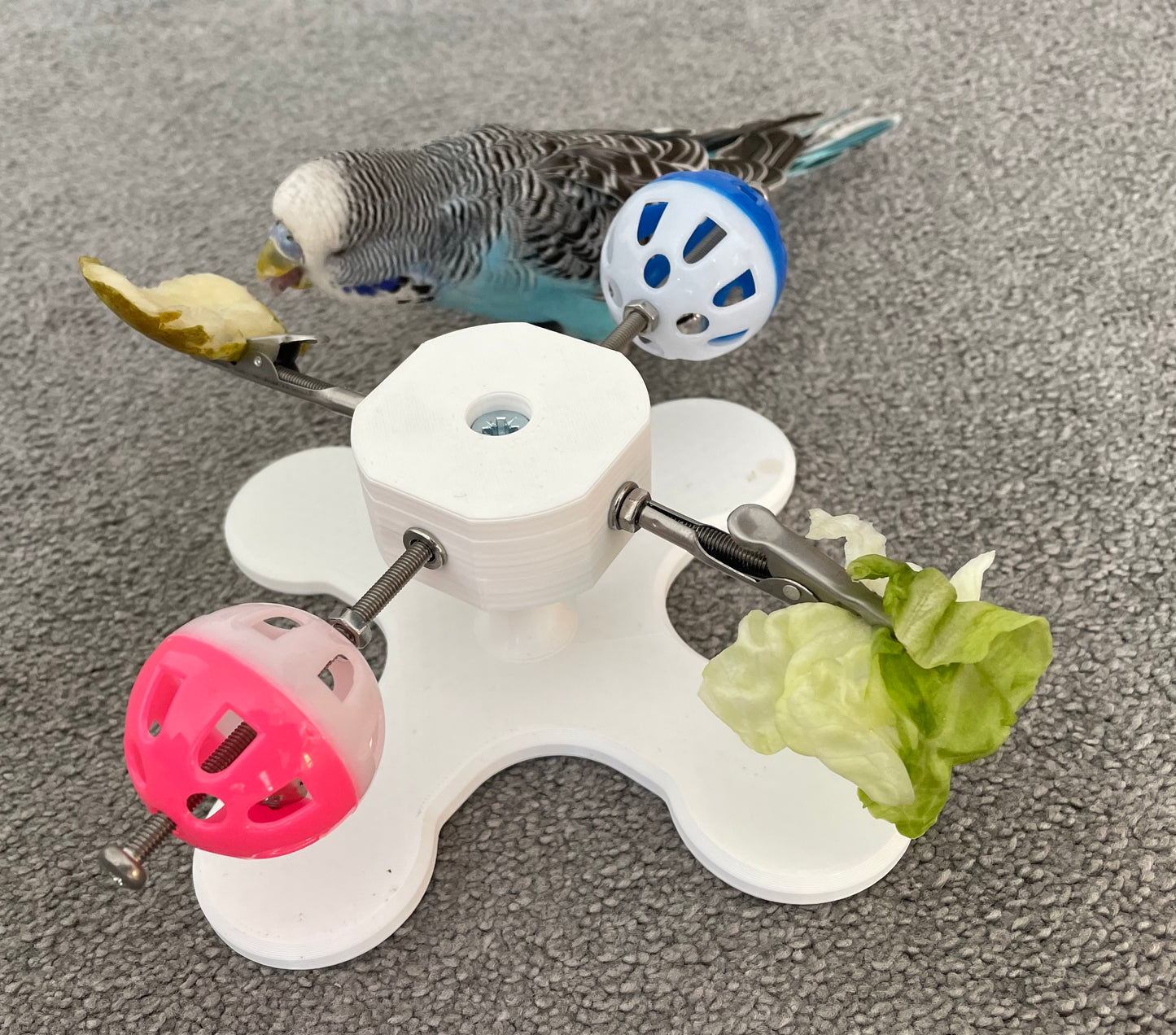 Rotating Bird Toy With Food Clips To Hold Treats.